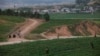 FILE - North Korean farmers tend a field outside Pyongyang, June 14, 2012. A U.N. report released July 16, 2024, accuses the Democratic People's Republic of Korea of widespread forced labor in a variety of sectors, including agriculture.