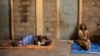 FILE - People displaced due to the fighting rest outside their shelter at the Abi Adi camp for internally displaced in Abi Adi, Tigray region, Ethiopia, June 24, 2023.