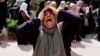 FILE — A woman mourns at the funeral of four Palestinians killed in clashes with Israeli settlers, near Nablus in the Israeli-occupied West Bank, Oct. 12, 2023.