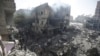 FILE - Palestinians look at the aftermath of the Israeli bombing in Nuseirat refugee camp, Gaza Strip, on June 8, 2024. The U.N. human rights office is citing possible war crimes by Israeli forces and Hamas in connection with a raid that freed four hostages over the weekend. 
