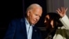 Vice President Kamala Harris speaks with President Joe Biden on a White House balcony during an Independence Day celebration in Washington, July 4, 2024. 