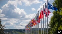 FILE — Flags of NATO member countries flap outside the venue of the NATO summit in Vilnius, Lithuania, July 9, 2023. Washington and NATO allies said Tuesday they will echo Russia's suspension of a Cold War treaty to limit conventional arms proliferation in Europe.
