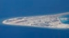Chinese structures and an airstrip on the man-made Subi Reef at the Spratly group of islands in the South China Sea are seen from a Philippine Air Force C-130 transport plane of the Philippine Air Force, April 21, 2017. 