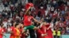 Portugal's Otavio celebrates with team mates after the World Cup quarterfinal soccer match between Morocco and Portugal, at Al Thumama Stadium in Doha, Qatar, Saturday, Dec. 10, 2022. 