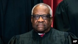 FILE - Justice Clarence Thomas sits during a group photo at the Supreme Court in Washington, April 23, 2021.