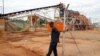 FILE - A private security employee guards a diamond processing plant in the diamond-rich eastern Marange region on December 14, 2011.