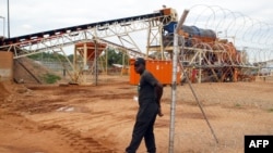 FILE - A private security employee guards a diamond processing plant in the diamond-rich eastern Marange region on December 14, 2011.