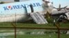 A security guard walks beside a damaged Korean Air plane on Oct. 24, 2022 after it overshot the runway at the Mactan-Cebu International Airport in Cebu, central Philippines. 