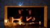 Staff at an eatery work by candle light after a failure in Bangladesh's national power grid plunged much of the country into a blackout in Dhaka, Bangladesh, Oct.4, 2022. 