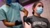 FILE - Sean Bagley, 14, receives the Pfizer-BioNTech COVID-19 booster vaccine targeting BA.4 and BA.5 Omicron subvariants at Skippack Pharmacy in Schwenksville, Pa., Sept. 8, 2022. 