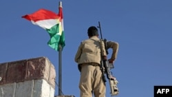 FILE - A Kurdish peshmerga fighter affiliated with the Iranian Kurdistan Democratic Party stands guard in Koye, Iraqi Kurdistan, Oct. 1, 2022. Iranian strikes targeted Kurdish militants in Iraq's north, an Iranian Kurdish official said, days after cross-border attacks killed 14.