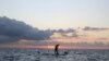 FILE - A standup paddle boarder is seen in waters between Cyprus and Lebanon, near Cape Greco Peninsula, Cyprus, Oct. 16, 2020. Both countries are locked in a dispute over their maritime border.
