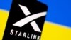FILE - The Starlink logo is seen on a smartphone in front of a displayed Ukrainian flag in this illustration taken Feb. 27, 2022. 