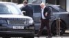 Former British Prime Minister Boris Johnson walks, at Gatwick Airport, near London, Oct. 22, 2022.