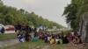 MALAYSIA-MYANMAR-PRISON-IMMIGRATION-ROHINGYA This handout taken and released by the Royal Malaysia Police on April 20, 2022 shows Rohingya refugees, who had escaped from Malaysian Immigration's temporary Sungai Bakap depot, detained on the side of a highw