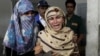 Rukhsana Bibi, center, mourns her daughter, polio worker Madiha Bibi, killed by unknown gunmen, at a local hospital in Karachi, Pakistan, Dec. 18, 2012. 
