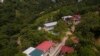 Police conduct a raid against alleged migrant smugglers near the Mexican border in Huehuetenango, Guatemala, Aug. 2, 2022. Guatemalan authorities have arrested more than a dozen alleged members of a migrant smuggling network near the shared border with Me