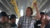 Sergei Polonsky was escorted by immigration police before he was deported from Cambodia, in a photo supplied by national police website. 