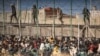 Riot police officers cordon off the area after migrants arrive on Spanish soil and crossing the fences separating the Spanish enclave of Melilla from Morocco in Melilla, Spain, June 24, 2022.