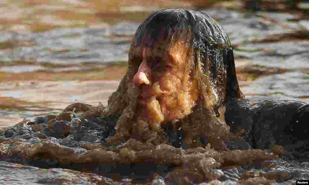 A competitor shakes water off his head during the Tough Guy event in Perton, central England, Feb. 1, 2015.