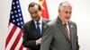 Secretary of State Rex Tillerson, right, and China's Foreign Minister Wang Yi walk to their seats before a meeting on the sidelines of a gathering of foreign ministers of the G-20 in Bonn, Germany, Feb. 17, 2017. 