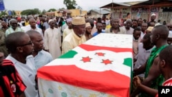 Men carry the coffin of UPD-Zigamibanga party Zedi Feruzi, during his funeral, in Bujumbura, Burundi, Sunday, May 24, 2015.