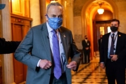 FILE - Senate Majority Leader Chuck Schumer of N.Y., heads to an interview on Capitol Hill in Washington, Jan. 25, 2021.