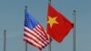 FILE - The U.S. flag flutters next to the Vietnamese flag during a welcoming ceremony for the U.S. defense secretary in Hanoi, Vietnam June 1, 2015. Vietnam has advocated for relaxation of the arms embargo to reflect a greater level of trust with the U.S.