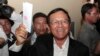 Opposition Cambodia National Rescue Party President Kem Sokha shows off his ballot before voting in local elections in Chak Angre Leu on the outskirts of Phnom Penh, June 4, 2017. 