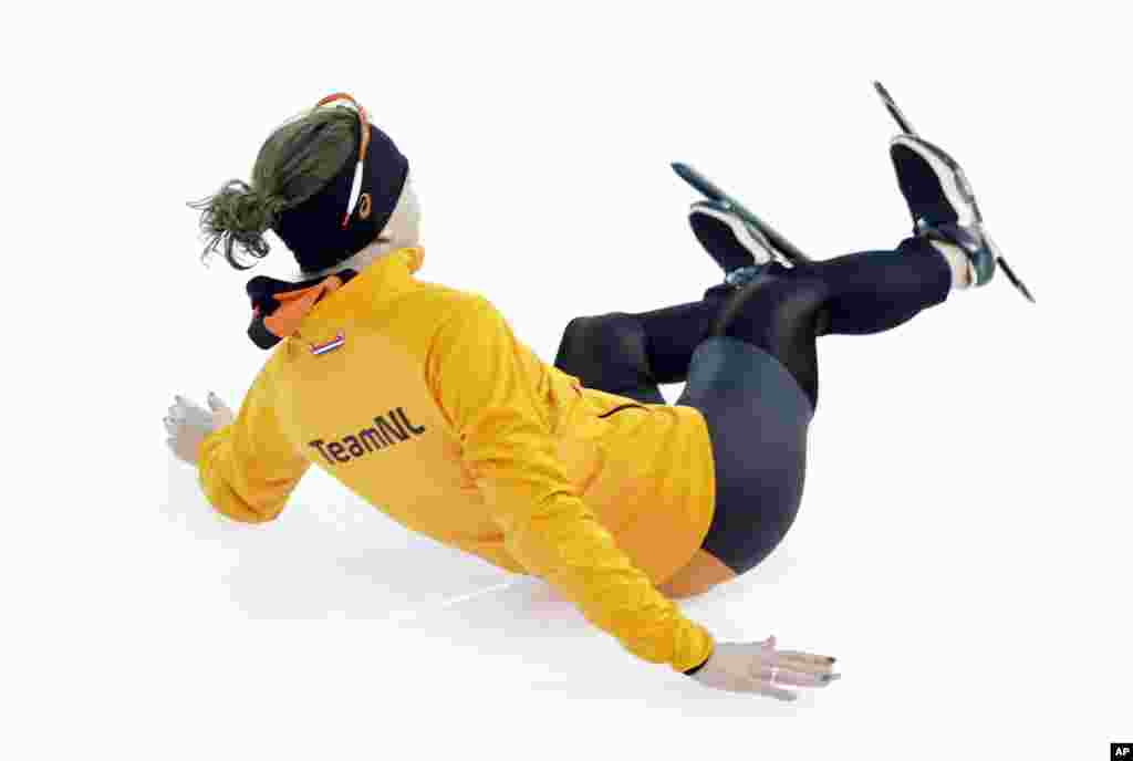 Ireen Wust of the Netherlands slides towards a team member as she celebrates winning gold in the women&#39;s 3,000-meter speedskating race at the Adler Arena Skating Center, Sochi, Russia, Feb. 9, 2014.