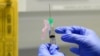 FILE - In this Wednesday, Aug. 5, 2020 file photo, senior Clinical Research Nurse Ajithkumar Sukumaran prepares the COVID 19 vaccine to administer to a volunteer, at a clinic in London. British scientists are beginning a small study comparing how two…
