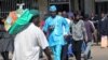 People walk down a street in the capital city of Zimbabwe, Harare, July, 12, 2012.