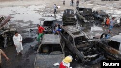 Residents gather at the site of bomb attacks in Baghdad, Iraq, May 27, 2013. 