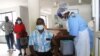 Zimbabweans get the COVID-19 vaccine at Wilkins hospital in Harare on Nov. 26, 2021. (Columbus Mavhunga/VOA)