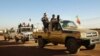 FILE - Soldiers from the Tuareg rebel group MNLA drive in a convoy of pickup trucks in the northeastern town of Kidal, Mali, February 4, 2013. 