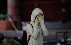 An anti-government demonstrator cries after coming out of the Hong Kong Polytechnic University (PolyU) to surrender, in Hong Kong, China, Nov. 19, 2019.