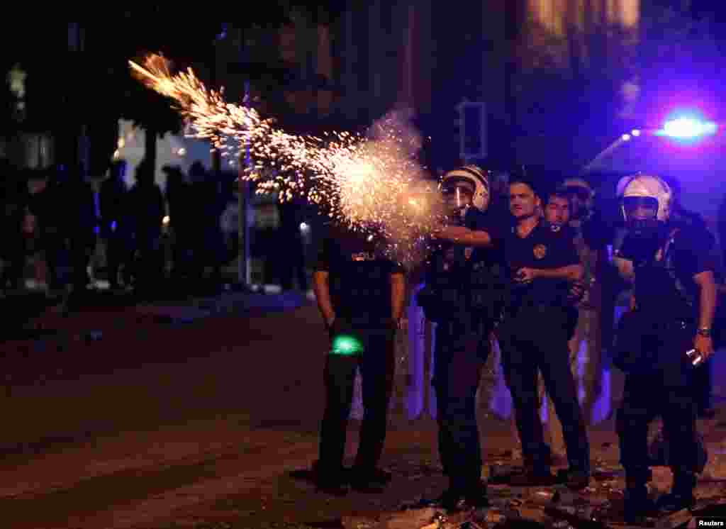 Riot police fire tear gas towards protesters during clashes on Kennedy Street in central Ankara, June 18, 2013.