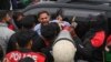 Police detain a supporter of former prime minister Imran Khan's Pakistan Tehreek-e-Insaf (PTI) party, at a protest against the alleged skewing in Pakistan's national election, in Lahore, on March 10, 2024.