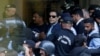 FILE - Officers escort Pakistan's former Prime Minister Imran Khan as he appears in Islamabad High Court on May 12, 2023. Pakistan's top court approved bail for Khan on Dec. 22, but because he is serving a sentence for an earlier conviction, he has not been released.
