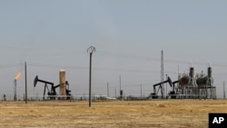 This July 30, 2017 photo, shows an oil field controlled by the Kurdish-led Syrian Democratic Forces (SDF), in Rmeilan, northeast Syria. The SDF, with air support from the U.S.-led coalition, said Sunday, Oct. 22, 2017 that they had captured the Al-Omar field, Syria’s largest oil field, from the Islamic State group.