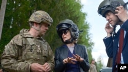 Прем'єр-міністерка Естонії Кая Каллас (у центрі) під час відвідин оборонних навчань розмовляє з командувачем британських сил в Естонії і послом Великої Британії в Естонії, 15 травня 2024 року. AP Photo/Hendrik Osula