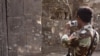 A Cambodian army soldier takes photographs of the damaged section of Cambodia's famed Preah Vihear temple, a UNESCO World Heritage site. 