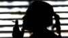 FILE - A woman smokes a cigarette in a parking lot in Bangkok, Thailand, May 27, 2010.