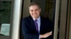 CNN's Jim Acosta walks out of the U.S. District Courthouse with a smile, Nov. 16, 2018, in Washington. 