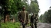 M23 rebel group soldiers patrol in Rangira, near Rutshuru, DRC, October 17, 2012.
