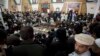 Maulana Abdul Aziz, center, in the background, the Red Mosque cleric and member of the Taliban negotiating team, addresses a news conference in Islamabad, Pakistan, Feb. 7, 2014.