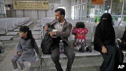 A Yemeni family waits in the departure hall at Sanaa International airport for a U.N. flight, Yemen, Feb. 3, 2020. The United Nations medical relief flight carrying patients from Yemen's rebel-held capital was the first in over three years. 