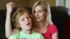 Colleen Jankovich looks over her 11-year-old autistic son, Matthew, who is non-verbal and requires 24/7 care, in Omaha, Nebraska, May 23, 2014.