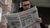 A man reads Cumhuriyet newspaper outside its Ankara office after Turkish police detained the chief editor and at least eight senior staff of Turkey's opposition newspaper, Oct. 31, 2016. The headline reads: "The coup against opposition again."