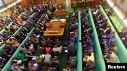 FILE - Ugandan lawmakers gather in the parliament to debate a move to change the constitution to extend the president's rule, in Kampala, Uganda, Sept. 21, 2017.